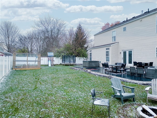 view of yard with a playground, a patio, a hot tub, and a trampoline