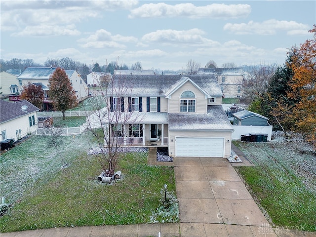 view of front of house featuring a garage, a porch, and a front yard