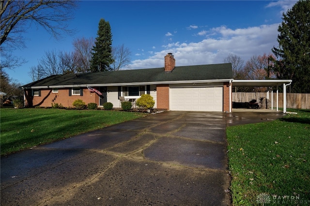 ranch-style home with a carport, a garage, and a front yard