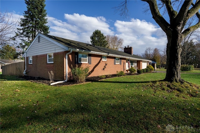 view of side of home with a lawn