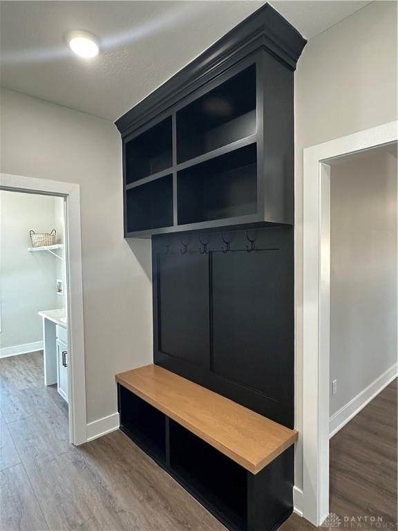 mudroom featuring baseboards and wood finished floors