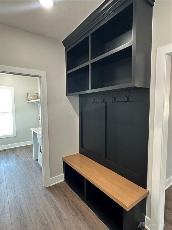 mudroom featuring baseboards and wood finished floors