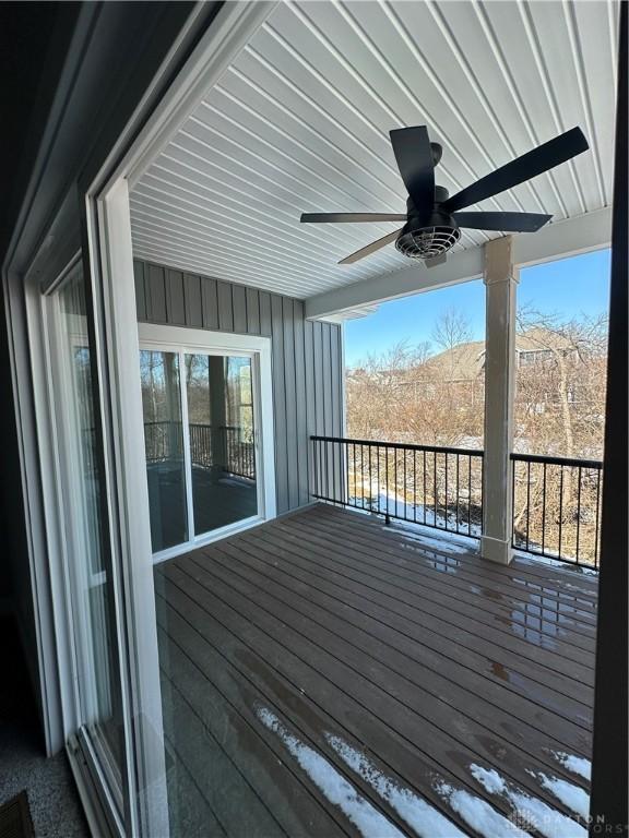 wooden deck with a ceiling fan