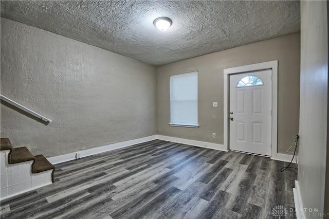 entryway featuring dark hardwood / wood-style flooring and a textured ceiling