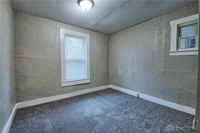 unfurnished room featuring carpet