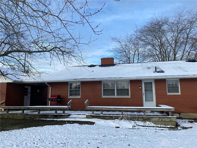 view of snow covered rear of property