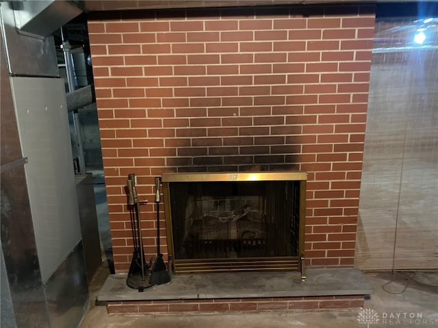 details with a fireplace and concrete flooring