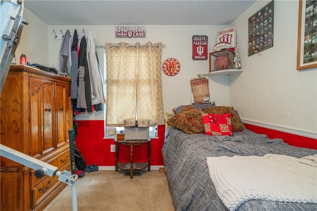 carpeted bedroom featuring a textured ceiling