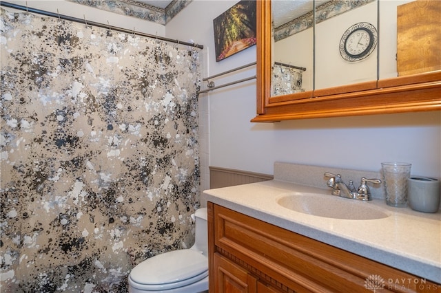 bathroom featuring vanity, toilet, and walk in shower