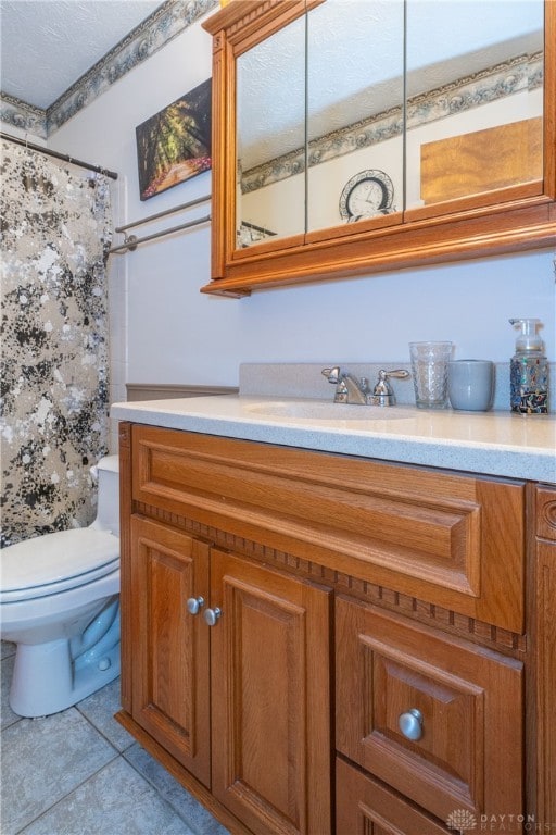 bathroom featuring walk in shower, tile patterned flooring, vanity, and toilet