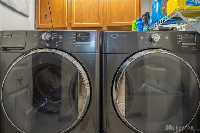 laundry area with cabinets and independent washer and dryer