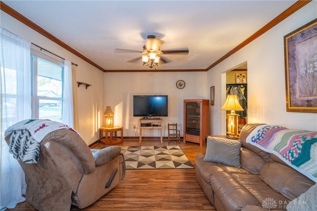 living room featuring ceiling fan, ornamental molding, and hardwood / wood-style flooring