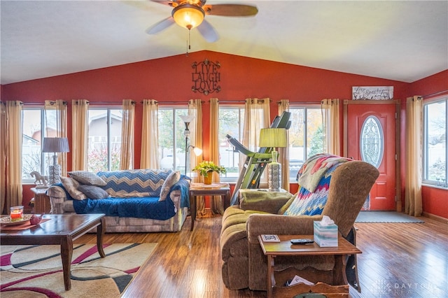 living room with wood-type flooring, lofted ceiling, and a wealth of natural light