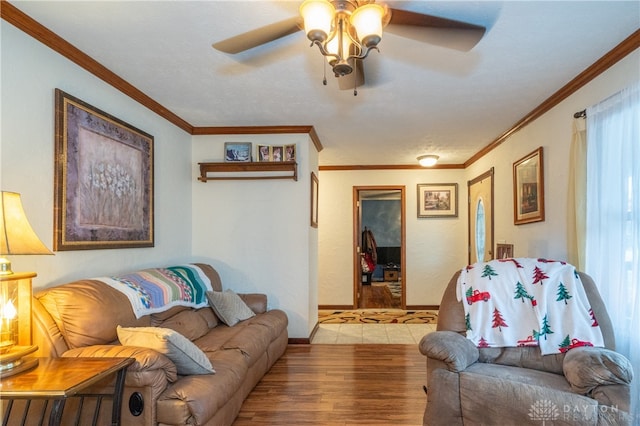 living room featuring light hardwood / wood-style flooring, ceiling fan, and ornamental molding