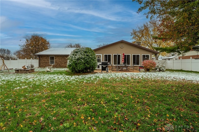 back of property with a yard and a patio area