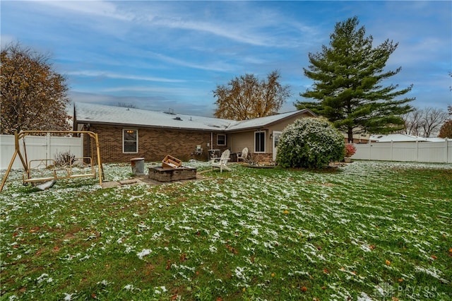 back of house with a lawn