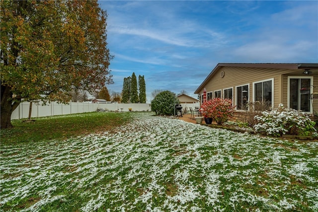 snowy yard with a patio area