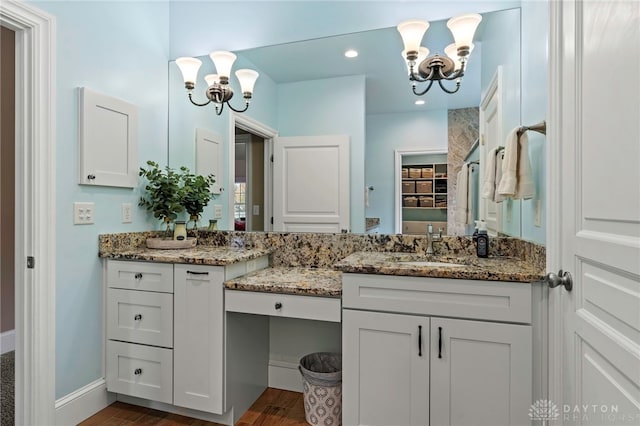 bathroom with a chandelier, vanity, and hardwood / wood-style flooring