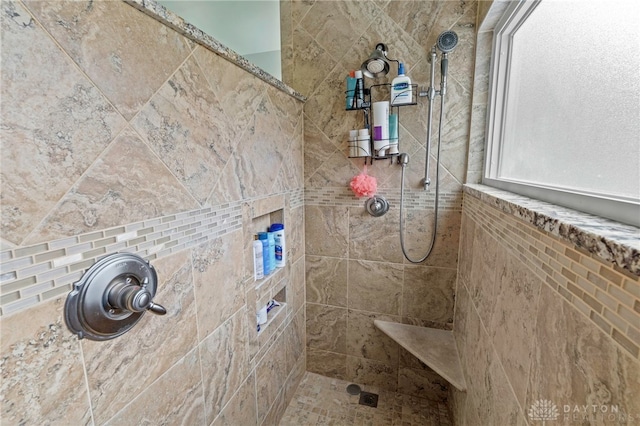 bathroom with a tile shower