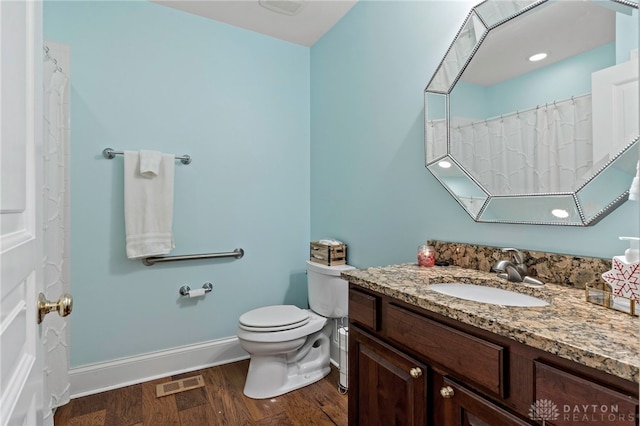 bathroom featuring hardwood / wood-style floors, vanity, and toilet