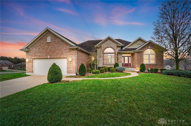 view of front of house featuring a yard and a garage