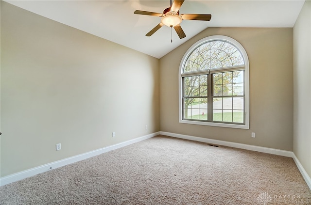 carpeted spare room with ceiling fan and lofted ceiling