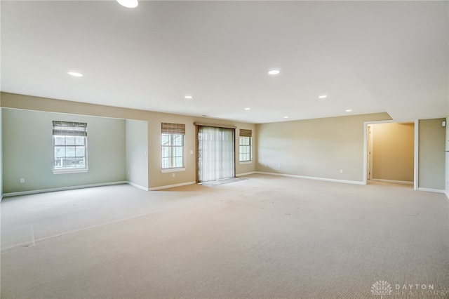 carpeted empty room featuring a wealth of natural light