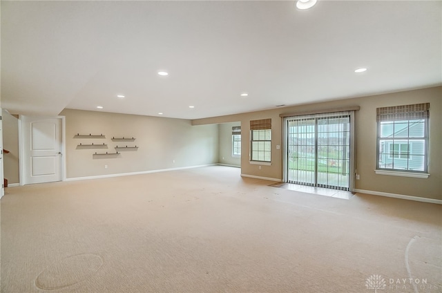 carpeted spare room with a wealth of natural light