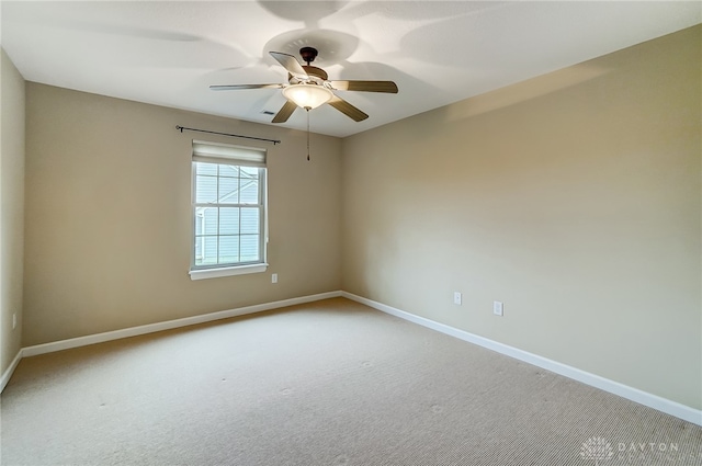 spare room featuring ceiling fan and carpet floors