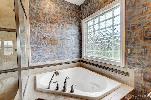 bathroom with tiled bath and tile walls