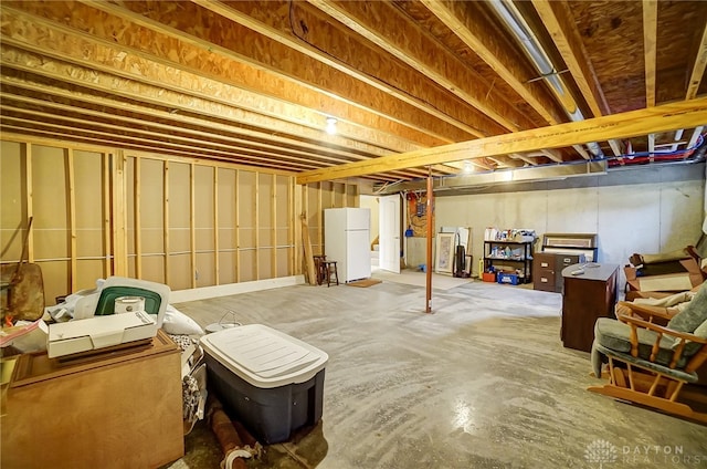 basement featuring white refrigerator