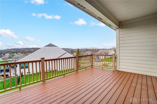 wooden deck featuring a yard