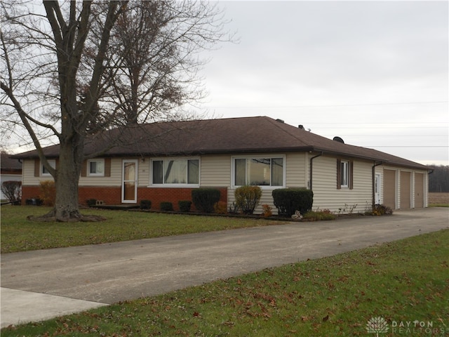 ranch-style house with a garage and a front yard