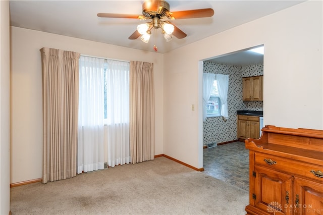 unfurnished room featuring light carpet and ceiling fan