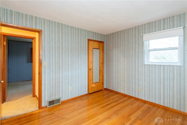 empty room with hardwood / wood-style floors