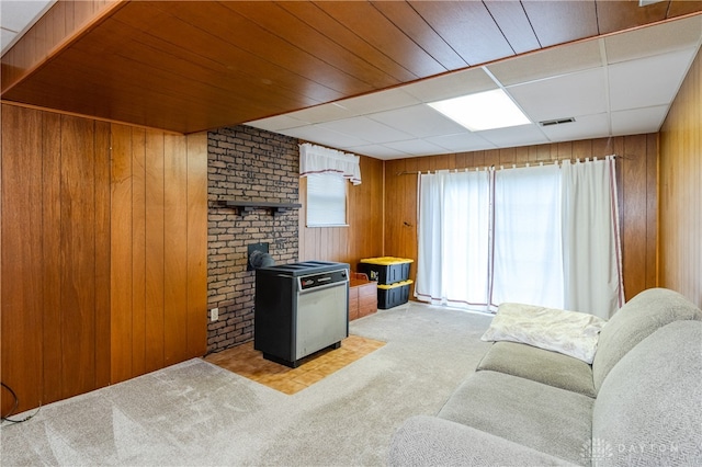 living room with light carpet and wooden walls