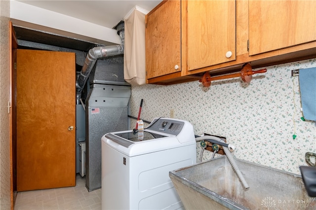 washroom with cabinets and washer / dryer