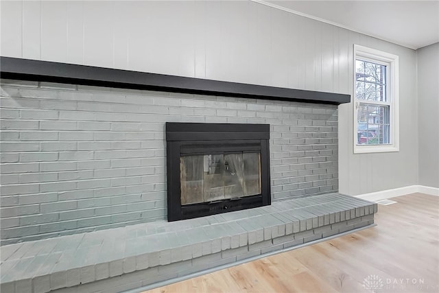 room details with hardwood / wood-style flooring and a fireplace