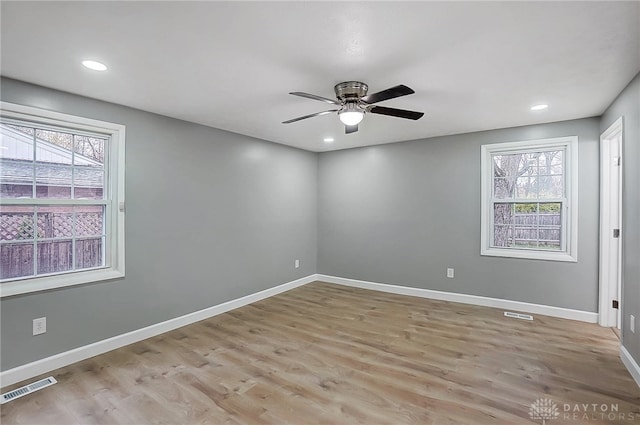 unfurnished room with ceiling fan, light hardwood / wood-style flooring, and a healthy amount of sunlight