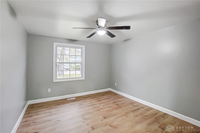 unfurnished room with ceiling fan and light wood-type flooring