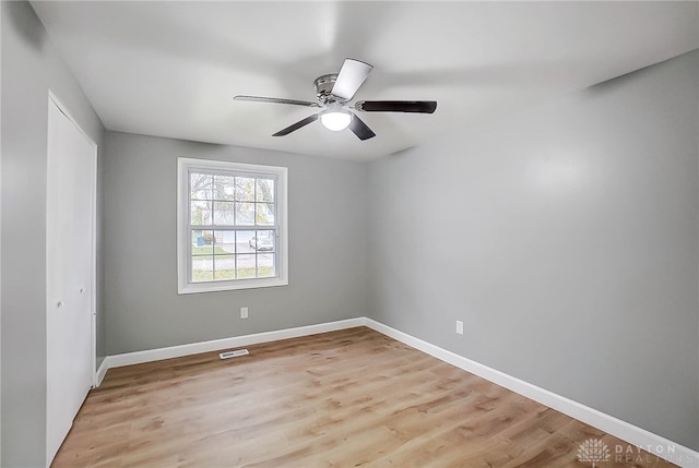 empty room with light hardwood / wood-style flooring and ceiling fan