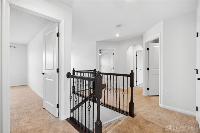 hallway featuring light colored carpet