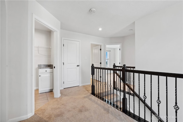 hallway with light colored carpet