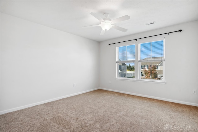 carpeted spare room with ceiling fan