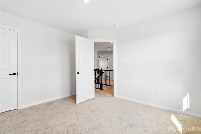 unfurnished bedroom featuring light colored carpet