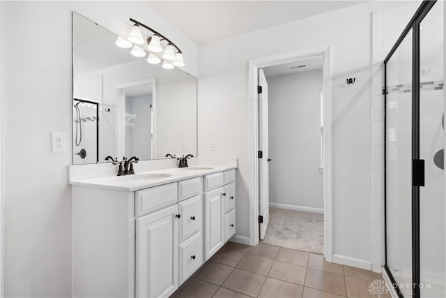 bathroom featuring tile patterned flooring, vanity, and an enclosed shower