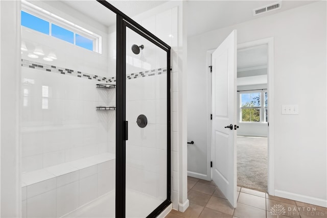 bathroom featuring tile patterned flooring and a shower with shower door