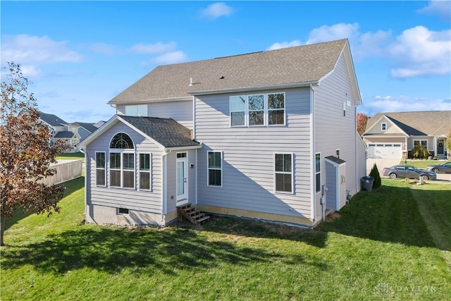 rear view of house featuring a yard