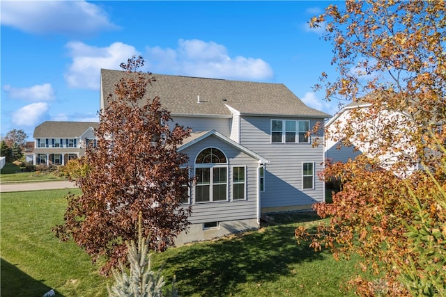 rear view of house with a lawn