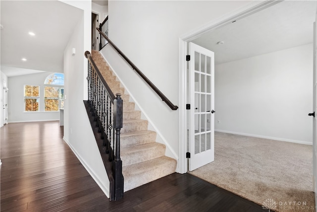 stairway with hardwood / wood-style floors